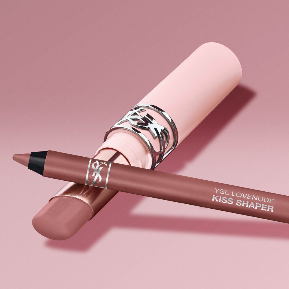 YSL LOVENUDE Kiss Shaper and Lip Blusher in Shade 1, digital still life on a soft pink background.