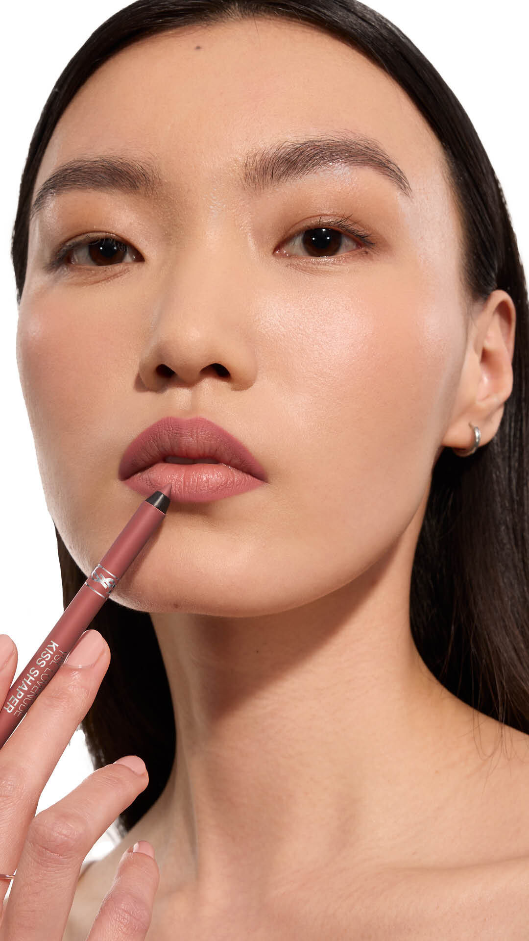 Jia Lu Yi applying YSL LOVENUDE Kiss Shaper 26 in Shade 101, full- face portrait on white background.