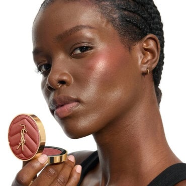 YSL Beauty model, with YSL LOVESHINE Plumping Lip Oil Gloss shade 10 near her deep-toned, shimmering lips.