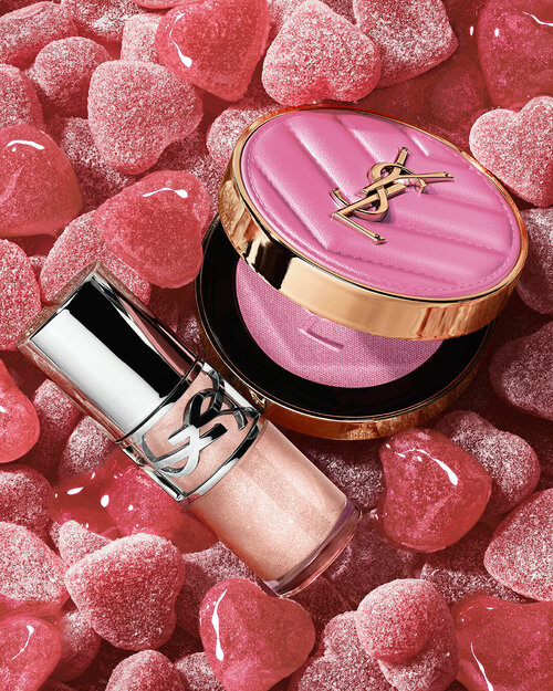 YSL LOVESHINE Plumping Lip Oil Gloss shade 10 and Make Me Blush shade 66, amidst vibrant pink heart-shaped sweets.