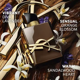 The YSL Cassandre gold rests on raw sandalwood, adorned with white orange blossoms and lavender, with text evoking the sensuality, vibration and energy of sandalwood.