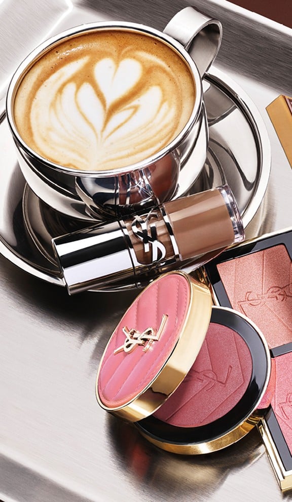 YSL Fall Drop latte makeup collection with Loveshine Lip Oil, Face Palette and Make Me Blush and a cup of coffee on a silver tray