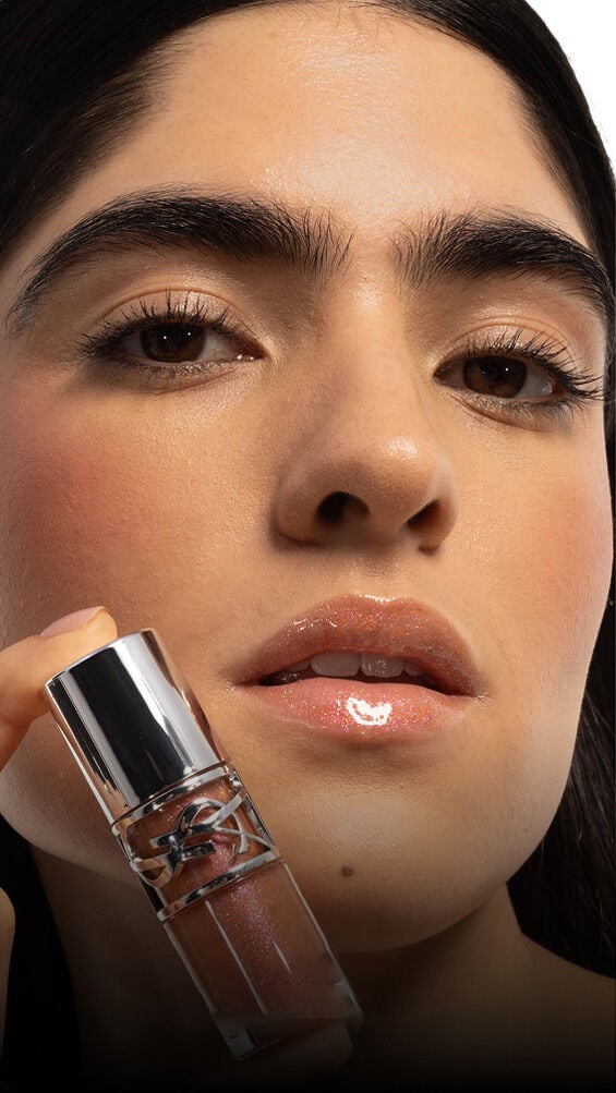 Model with medium skin tones wearing YSL Loveshine Lip Oil Gloss Honey Moon