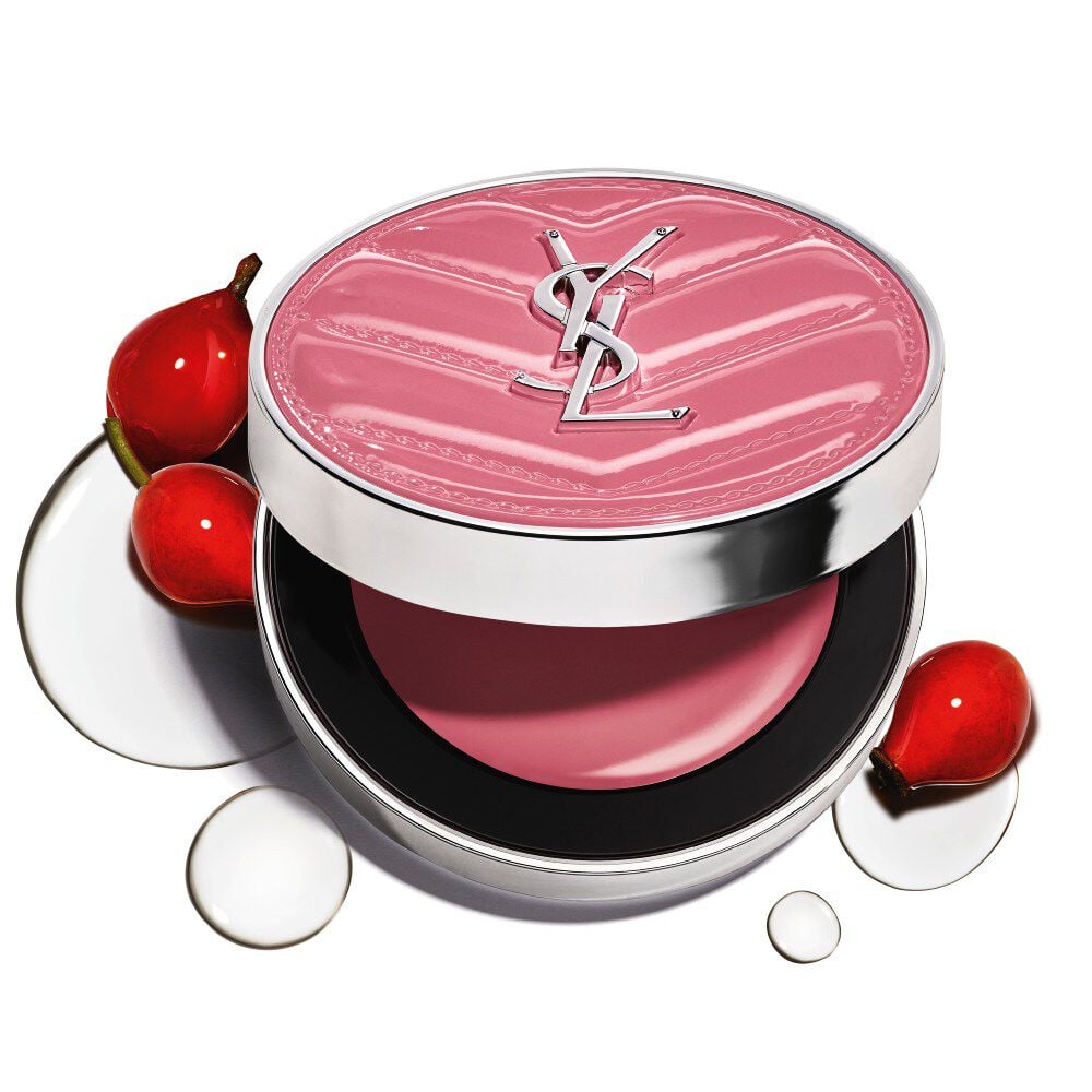 An open YSL Make Me Blush Lifted Glow Cream Blush compact in shade #44 Nude Lavallière surrounded by
fresh rosehip fruit extract and water droplets on a white background.