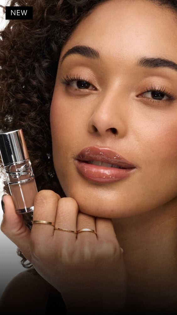 Model with medium skin tones wearing YSL Loveshine Lip Oil Gloss Cold Brew Craze