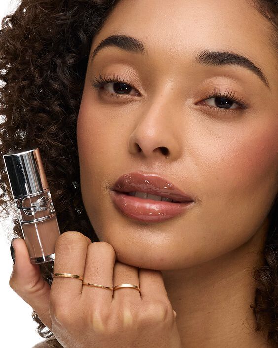 Model holding YSL Loveshine Lip Oil Gloss packshot