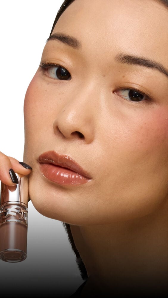 Model with light skin tones wearing YSL Loveshine Lip Oil Gloss Cold Brew Craze