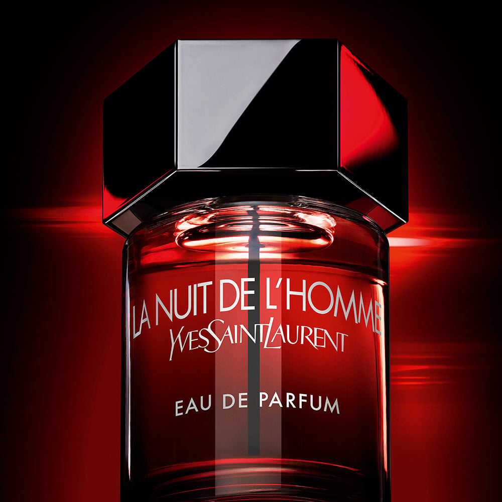 A cinematic, backlit shot of the bottle glowing with an intense red light
against a dark background, evoking a sense of mystery and
"incandescent" sensuality.